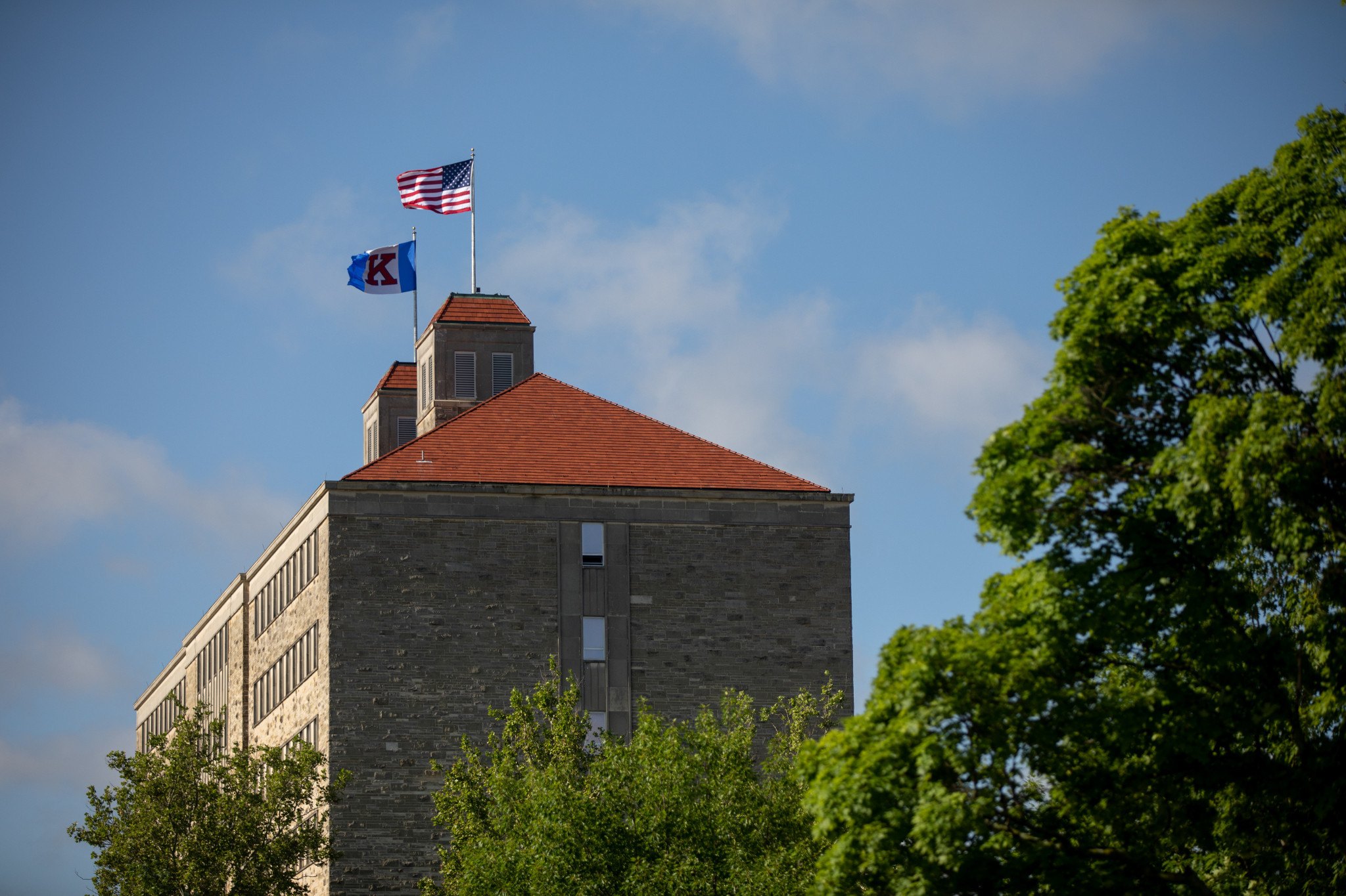 Fraser Hall the tallest building on campus with the flags on top